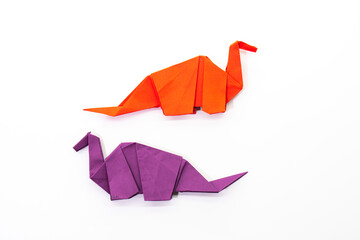 Paper dinosaur on white background. paper crafts. origami dinosaur. origami art. © Denis