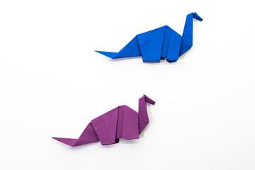 Paper dinosaur on white background. paper crafts. origami dinosaur. origami art. © Denis