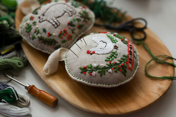 Pincushions with handmade embroidery, seamstress's tools