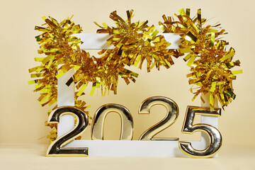 golden numbers 2025 two thousand twenty five new year near a white frame and yellow tinsel