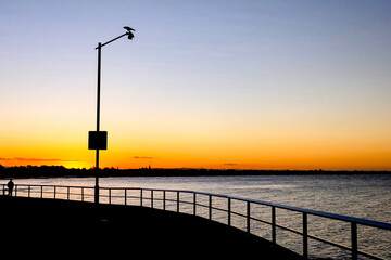 Sunset, purple and orange dawn sky at Shorncliffe pier, jetty, beach and bayside views, QLD