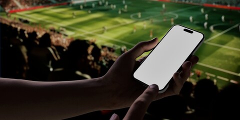 Black African-American old male using smartphone with a blank white screen. Soccer, stadium, spectators apps mockup. Vertical phone orientation