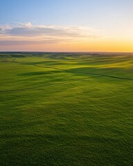Fototapeta premium Breathtaking sunset over expansive green fields nature photography open landscape aerial view tranquil beauty