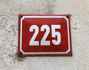 Red metal sign that says number 225
