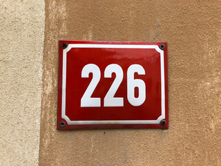 Red metal sign that says number 226