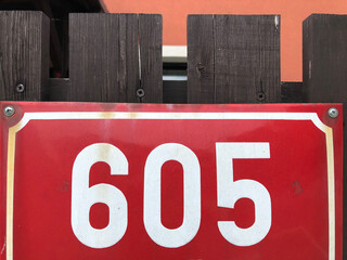 Red metal sign that says 605