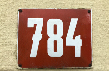 Red metal sign that says 784