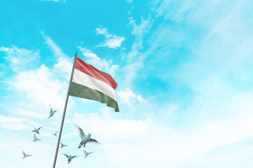 Hungary flag waving with flying doves in beautiful sky. Hungary flag for Republic Day and...