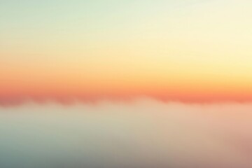 Obraz premium Soft pastel colors blend in the sky as the sun rises over a serene horizon at dawn