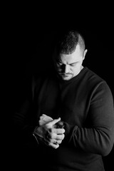 Introspective Man Checking His Watch in Low-Key Portrait