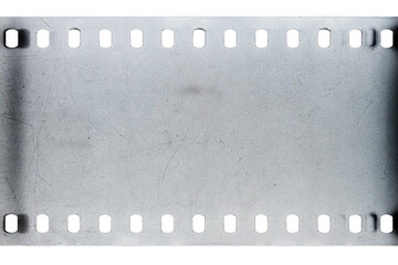Dusty and grungy 35mm film texture or surface. Perforated scratched camera film isolated on white...