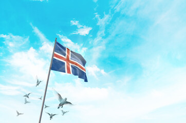 Iceland flag waving with flying doves in beautiful sky. Iceland flag for Republic Day and...