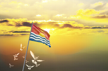 Kiribati flag waving with flying doves against sunset or sunrise. Kiribati flag for Republic Day and Independence Day.