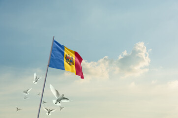 Moldova flag waving with flying doves in beautiful sky. Moldova flag for Republic Day and Independence Day.