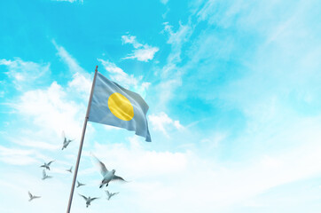 Palau flag waving with flying doves in beautiful sky. Palau flag for Republic Day and Independence...