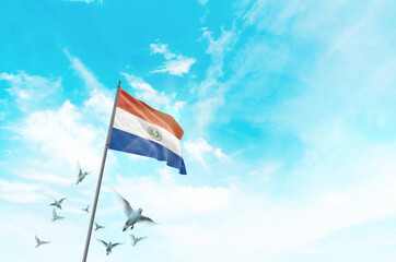 Paraguay flag waving with flying doves in beautiful sky. Paraguay flag for Republic Day and...