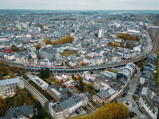 Aerial drone view of Esch-sur-Alzette city centre, Luxembourg showcasing urban landscape and surrounding nature in fall