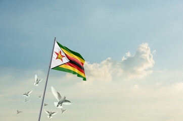 Zimbabwe flag waving with flying doves in beautiful sky. Zimbabwe flag for Republic Day and...
