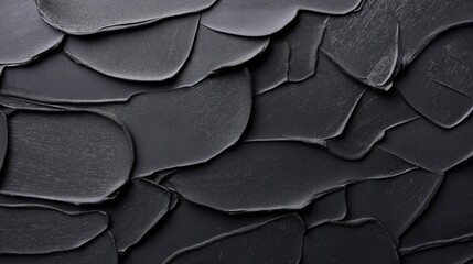 Obraz premium Close-up of layered black textured surface resembling abstract artistic brushstrokes or paint swatches