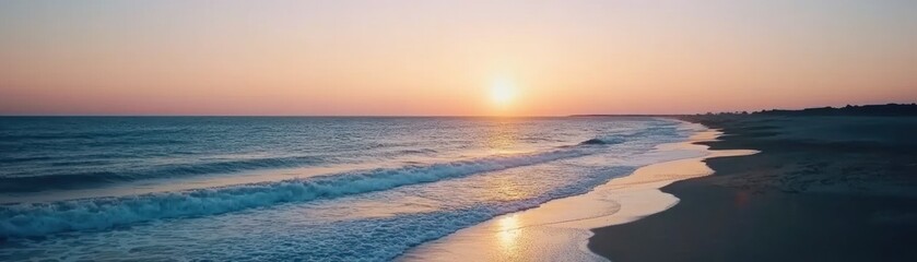 Fototapeta premium Serene sunset over a tranquil beach with gentle waves lapping at the shore.