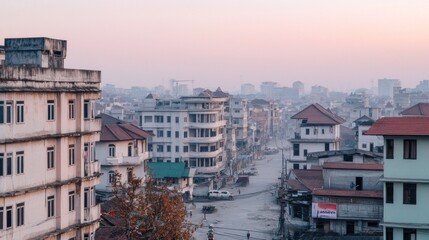 Naklejka premium Urban cityscape view at dawn with buildings and streets in soft morning light.