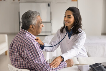 Latin cardiologist check heart rate of older male patient with stethoscope, monitoring heart rate...