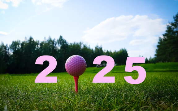 A vibrant pink golf tee with a golf ball ready for play, set against a lush green backdrop in 2025 concept