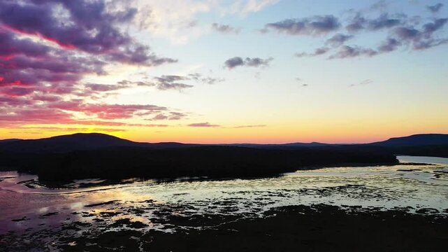 Tupper Lake in Adirondack, NY State, Moody Section, Spectacular Sunset in Fall aerial drone pan left