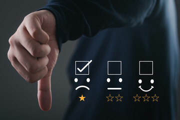 A hand gestures a thumbs down with rating icons, symbolizing negative feedback or dissatisfaction...