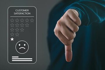 A hand making a thumbs down gesture symbolizes customer dissatisfaction and poor feedback in a...