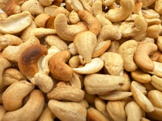 Cashew nuts on a rustic wooden background, natural texture, close-up view.