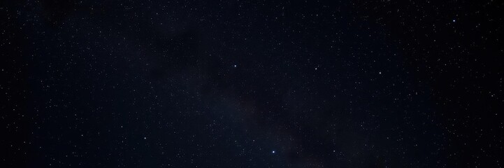 Fototapeta premium Night sky filled with sparkling stars on a dark background, tranquil, infinite