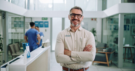 Doctor, portrait and hospital with chief, arms crossed and manager at clinic with smile. Mature,...