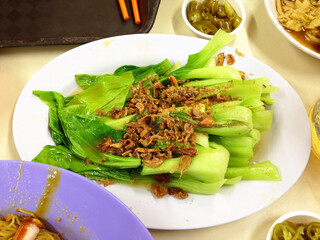 Delicious Chinese Bok Choy vegetable dish with garnish at a restaurant in Asia