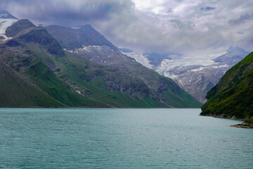 Kaprun high mountain reservoirs - dramatic environment in summer. August 20, 2024.