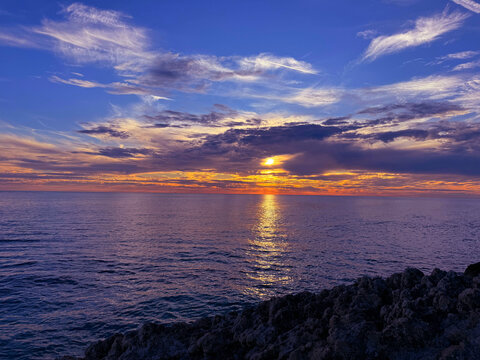 Amazing sunset sky and calm glittering sea at evening