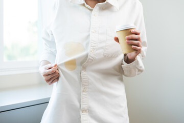 Cloth stain, disappointment asian young woman clumsy with hot coffee, tea stains on shirt, hand...