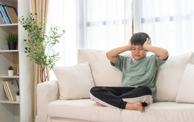 Portrait of sick depressed unhappy child boy touching on head feel suffering head ache pain flu...