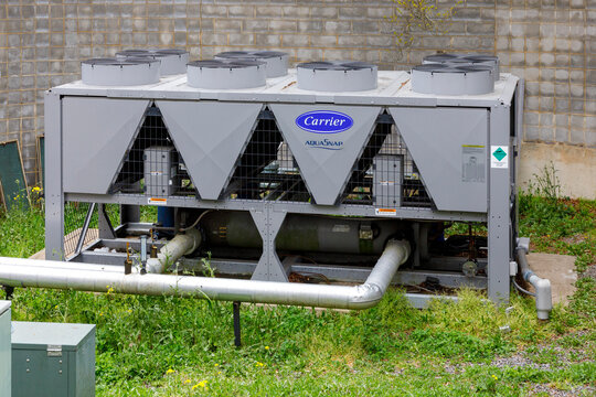ASHEVILLE, NC, USA-25 APRIL 2021: Carrier AquaSnap chiller installed behind secured concrete wall.