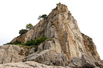 Cliff stone located part of the mountain rock isolated on white background.
