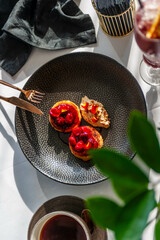 Light breakfast in a restaurant with coffee and pancakes with cherry jam