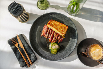 Hearty breakfast with beef steak, toast and crushed cucumbers