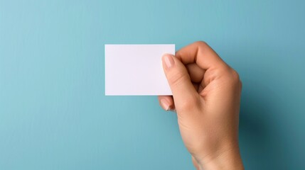 Obraz premium Hand holding blank card, blue background