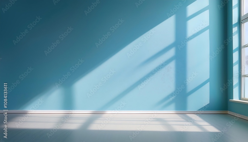 Poster shadows from a large window cross a soft blue wall as neutral light fills an empty room wit_1(673)