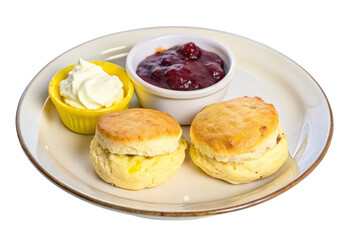 two scones with jam and butter on a white plate isolated with transparent background