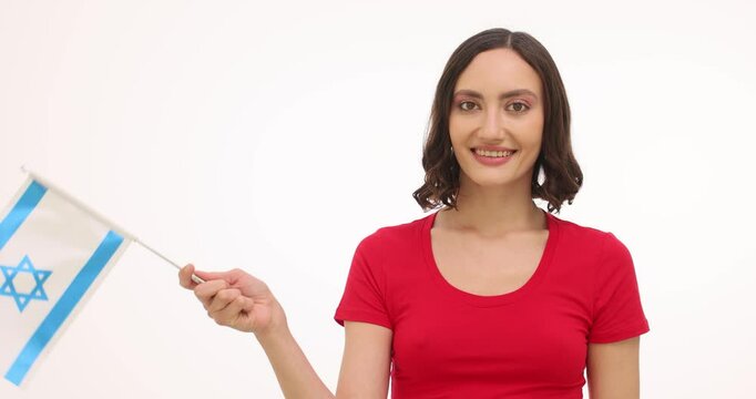 Woman waves flag of Israel showing proudness of native country on white background. Female expresses happiness celebrating national events