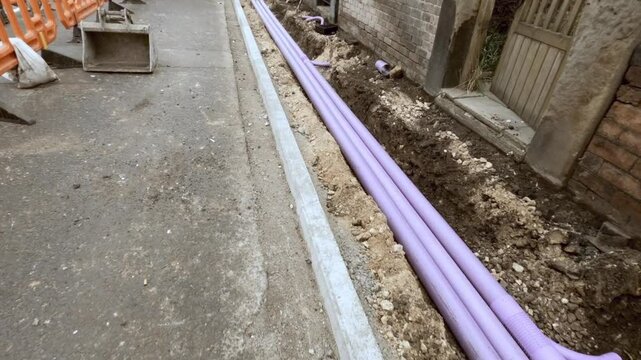 New telecom ducts for internet broadband cable installed along the city sidewalk for improved infrastructure upgrades
