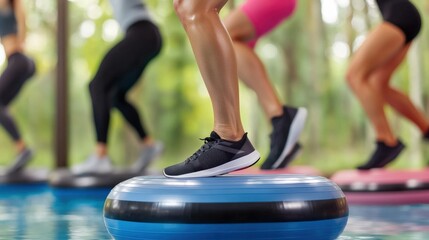 Naklejka premium A vibrant indoor fitness class with participants balancing on stability balls, demonstrating strength and coordination.