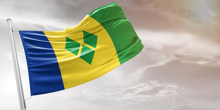 Saint Vincent and the Grenadines national flag cloth fabric waving on beautiful grey Background.