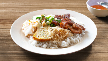 Broken rice with grilled pork chop, meatloaf and shredded pork skin. Vietnamese combination broken rice. Cơm Tấm Sườn Bì Chả. Vietnamese Broken Rice is served with grilled pork. Com tam suon bi cha